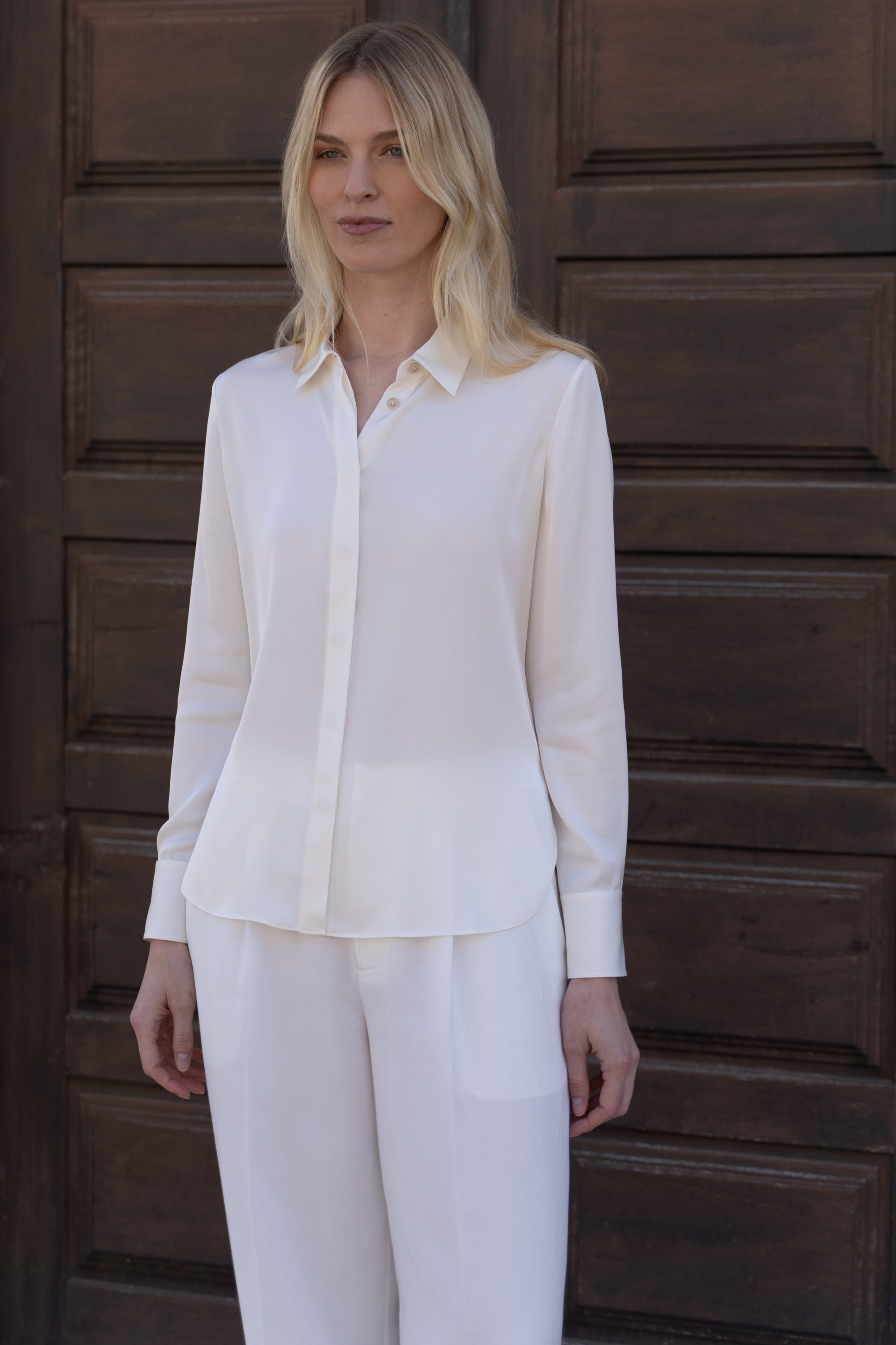 Quality offwhite silk blouse with concealed placket showcasing timeless appeal and sophisticated styling.