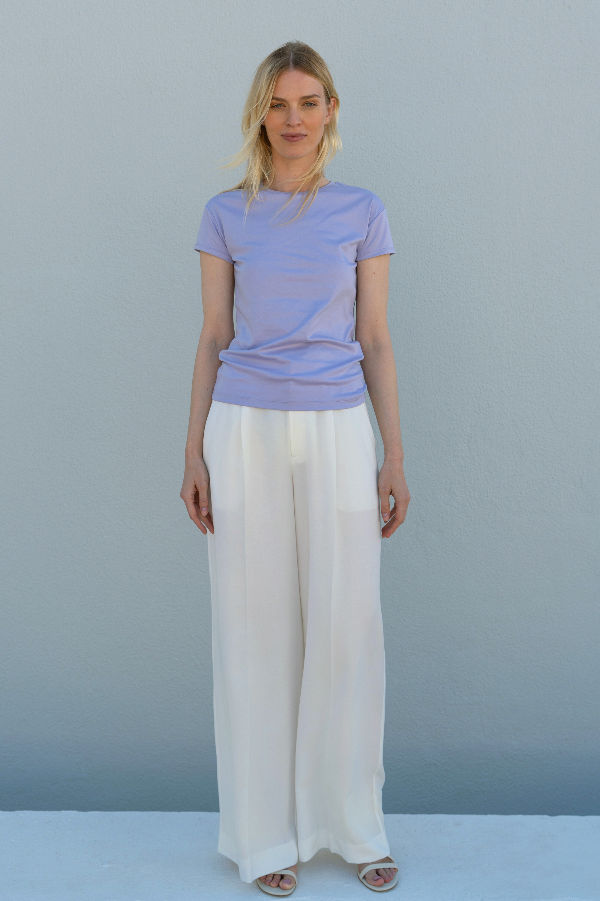 Elegant offwhite linen trousers featuring essential luxury and refined styling.
