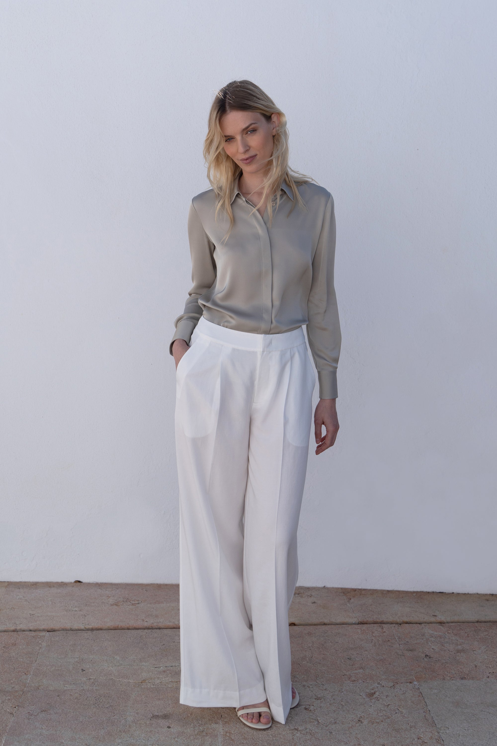 Timeless silver gray silk blouse with concealed placket displaying quality craftsmanship and elegant drape.