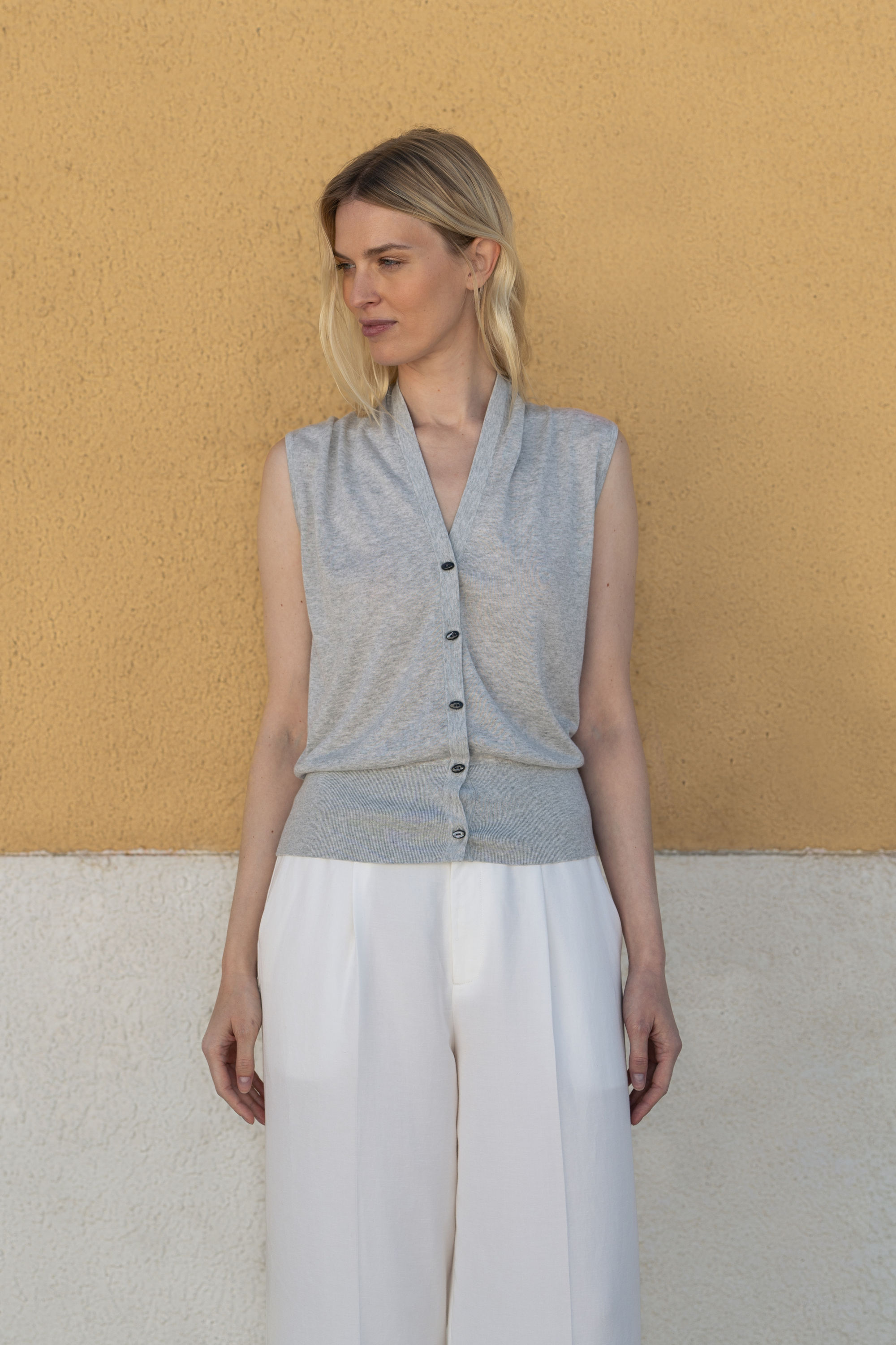 Elegant grey melange sleeveless knitted top featuring timeless quality and essential luxury.